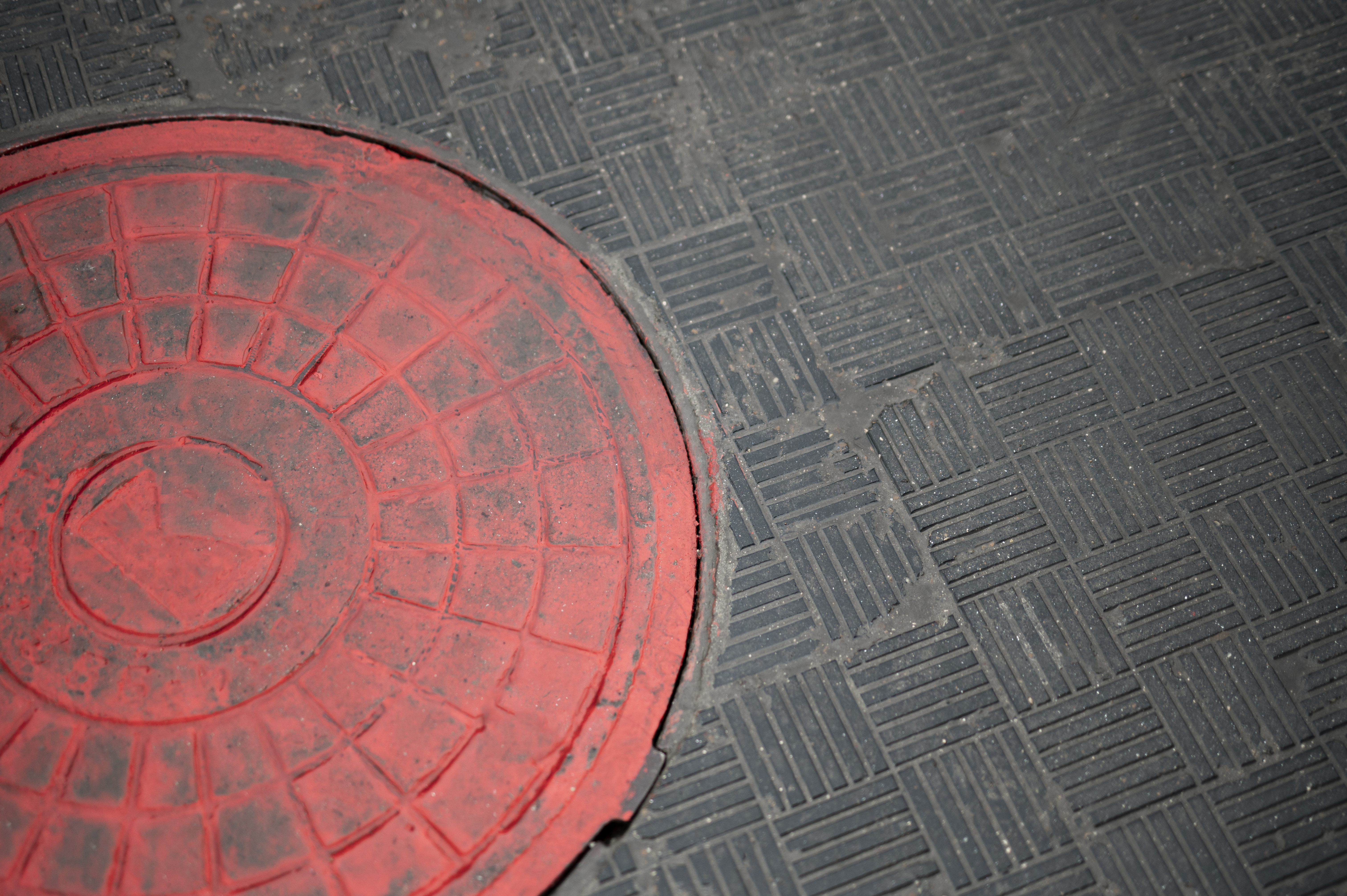 Outdoors cobblestone texture with manhole